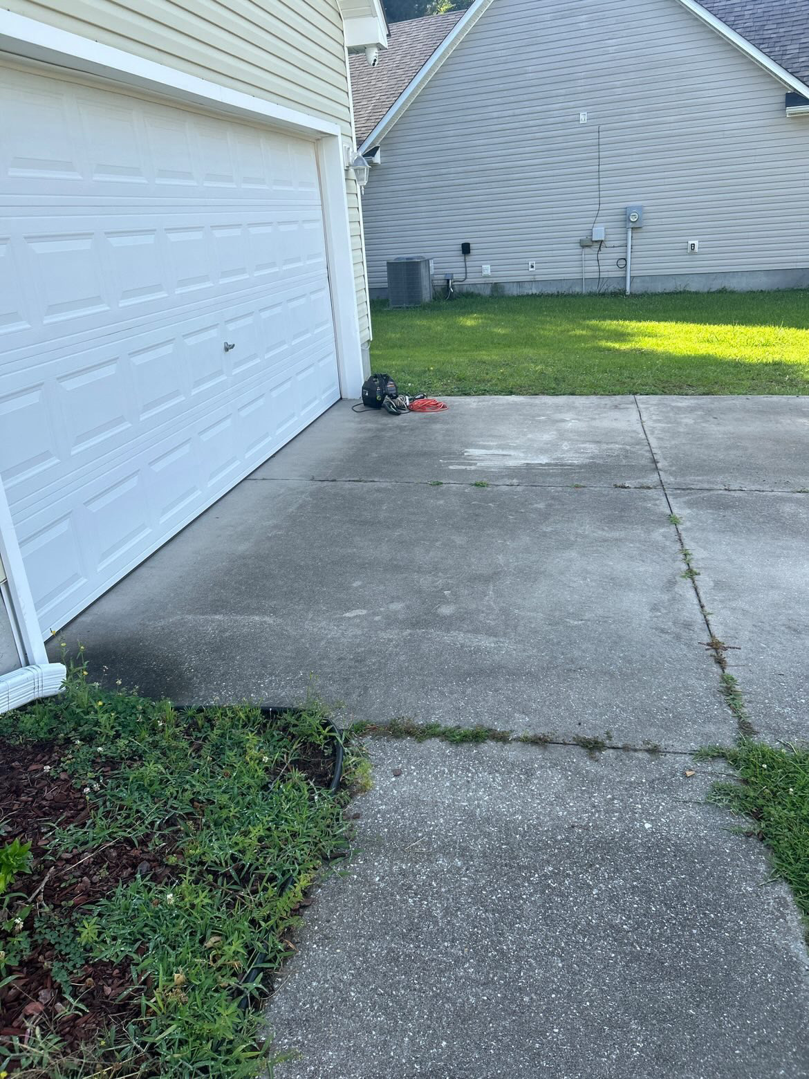 Curved concrete walkway beside a mulch bed