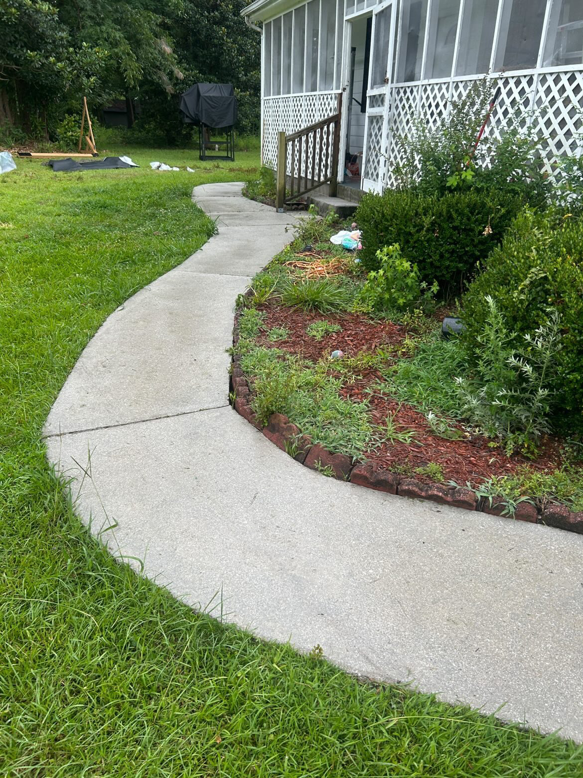 Concrete path beside a storage shed
